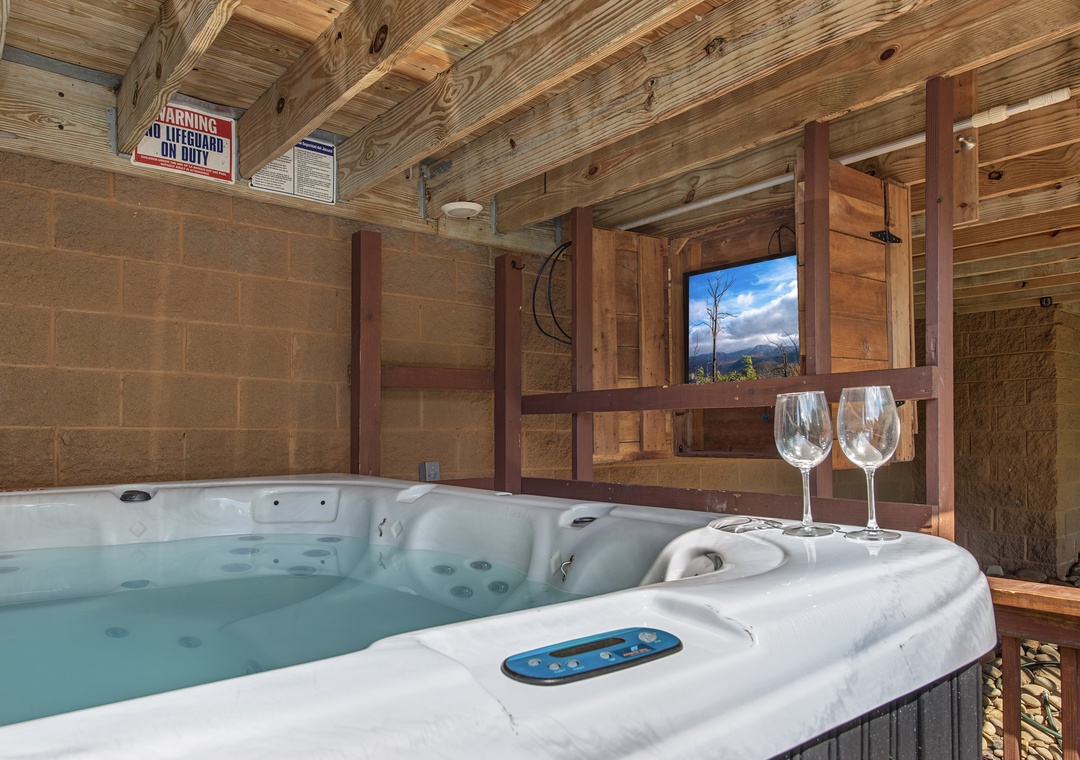 Slip into your private hot tub with mountain views and let the warm, bubbling water melt away tension—your secluded retreat under rustic wood beams, complete with wine glasses waiting for your arrival.