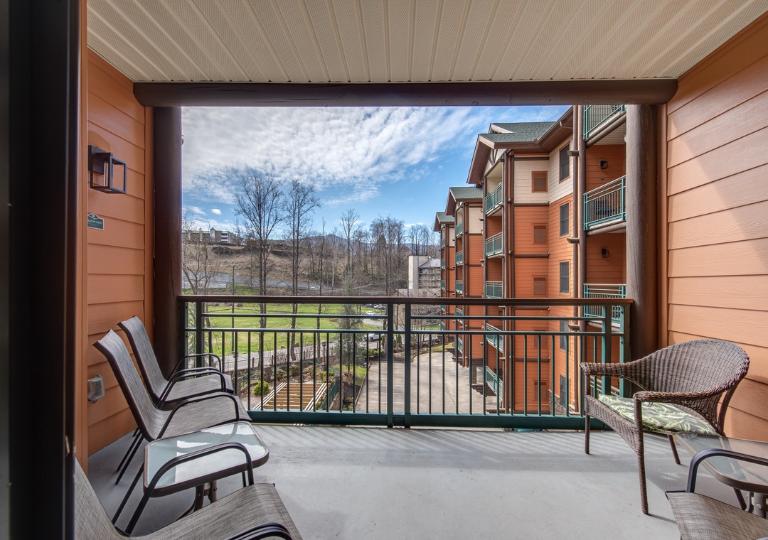 Step onto your private balcony and breathe in the fresh mountain air while enjoying comfortable seating with views of the surrounding buildings and landscape.