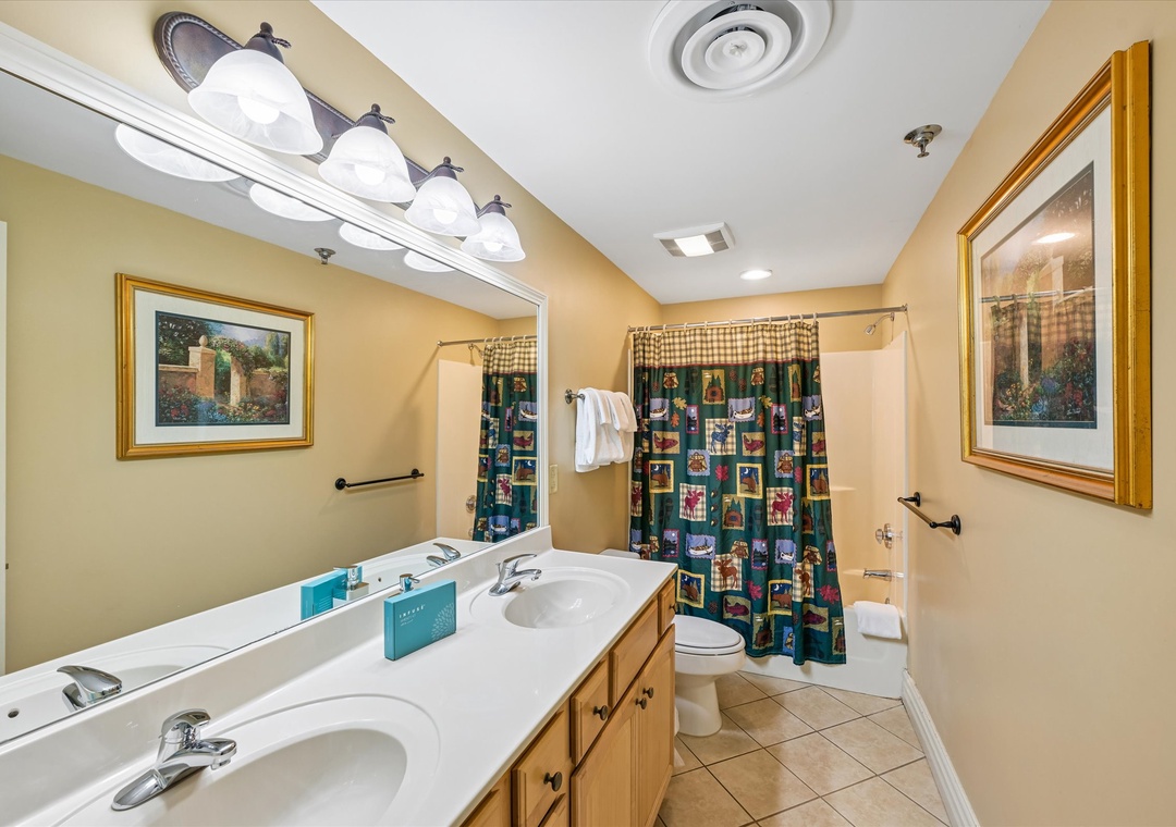 Freshen up in your spacious bathroom with dual vanities, classic finishes, and thoughtful touches that make your stay comfortable.