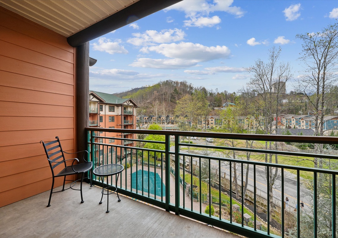 Spacious covered balcony offering elevated views of the surrounding mountain landscape and resort community below.