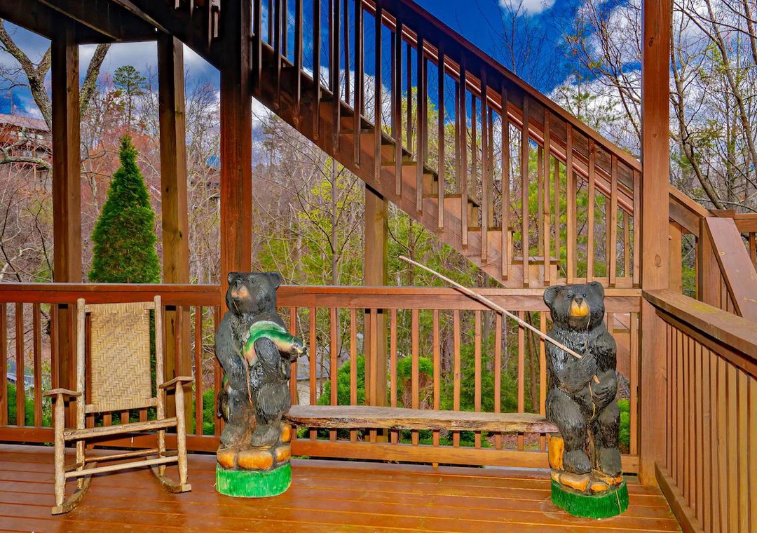 Step onto your private deck where whimsical bear sculptures guard your mountain retreat, creating a magical outdoor space.