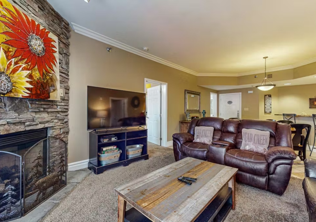 Unwind in your inviting living room with plush leather recliners, warm fireplace, and modern entertainment setup for cozy evenings together.