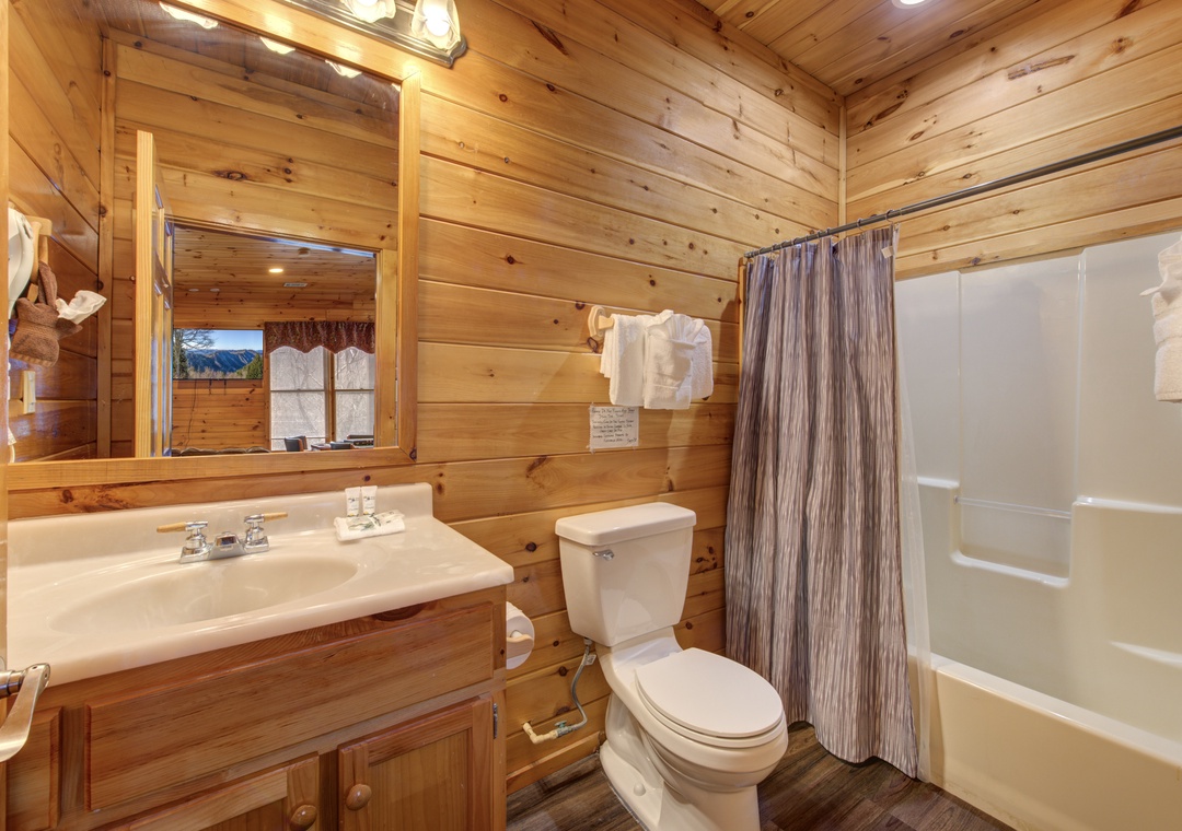 Step into your cozy log cabin bathroom with warm wood walls, modern fixtures, and everything you need for comfort.