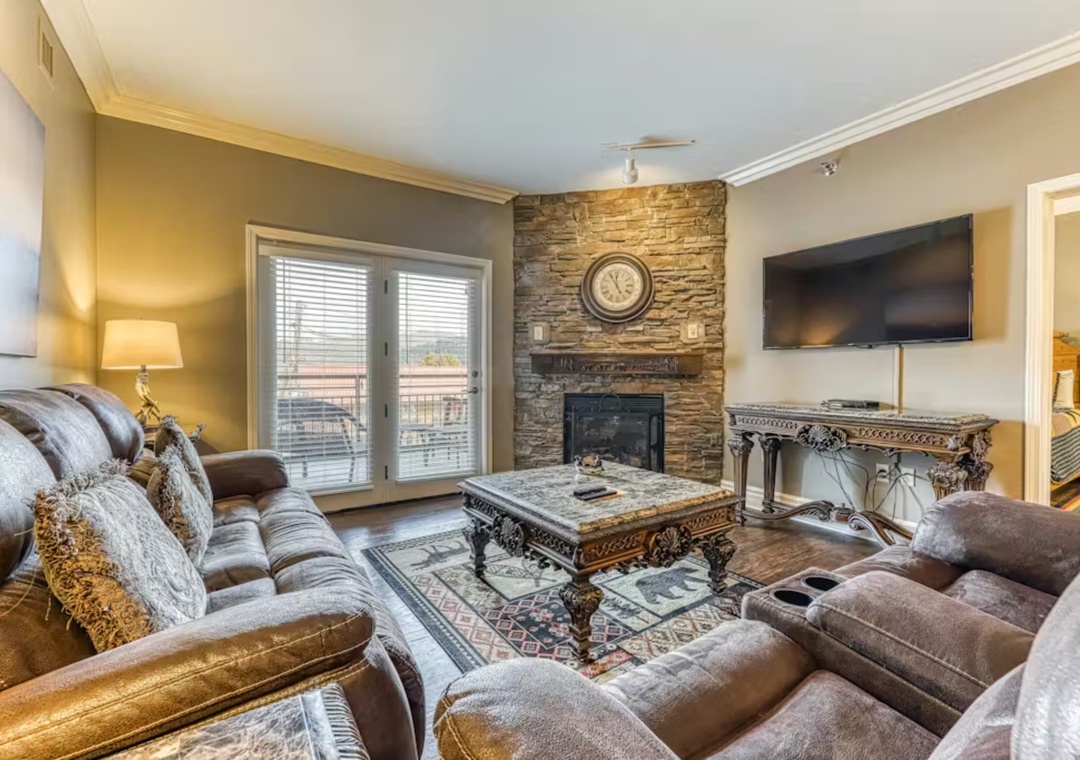 Sink into plush seating by your stone fireplace, where warm ambiance meets modern comfort for perfect relaxation.