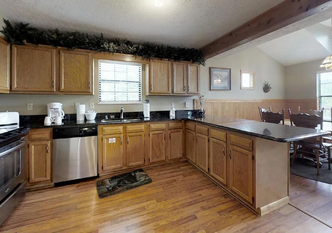 Step into your fully equipped kitchen with gleaming countertops, stainless appliances, and a sunny window. Just beyond, your dining table awaits memorable meals and laughter.