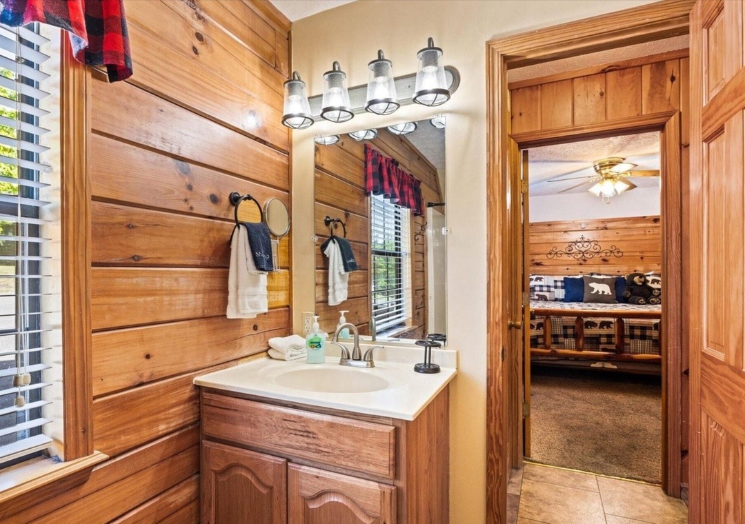 Step into your rustic bathroom with charming wood accents, mason jar lighting, and cabin-style vanity that makes every morning feel like a cozy retreat.