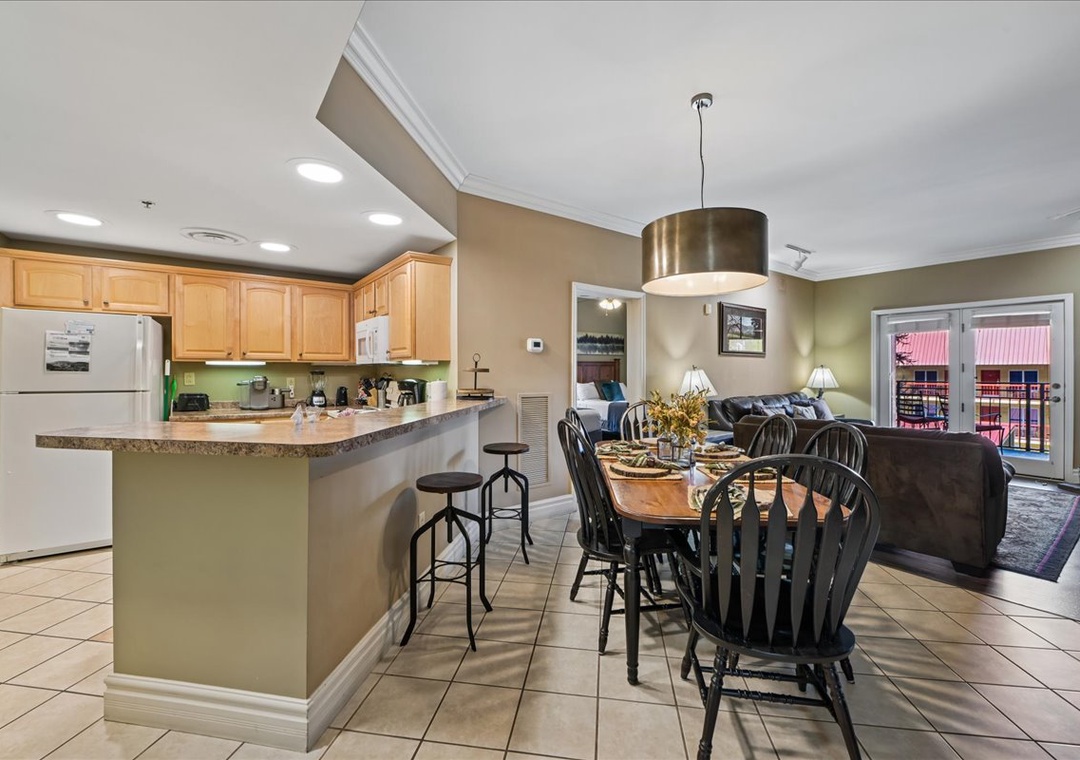 Prepare meals in your fully equipped kitchen, then gather around the dining table or relax in the comfortable living area with balcony access.