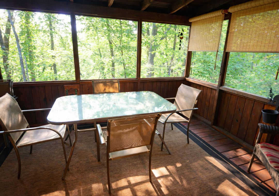 Gather around your private screened dining area, where forest views create a peaceful backdrop for morning coffee and evening meals together.