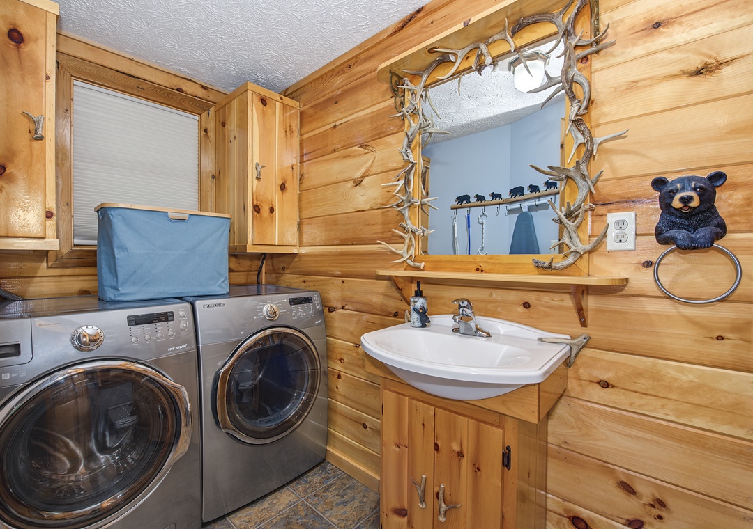 Your own washer and dryer make packing light a breeze, tucked into a cozy cabin-style space with rustic wood walls and charming bear-themed touches.