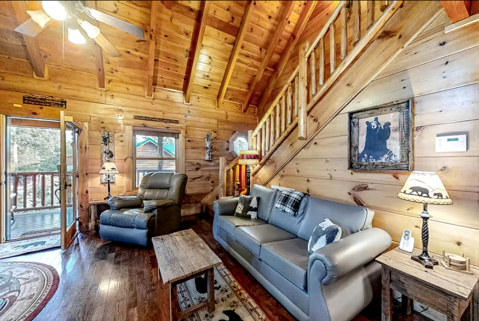 Sink into comfortable leather seating surrounded by warm pine walls and rustic charm in your cozy cabin retreat.