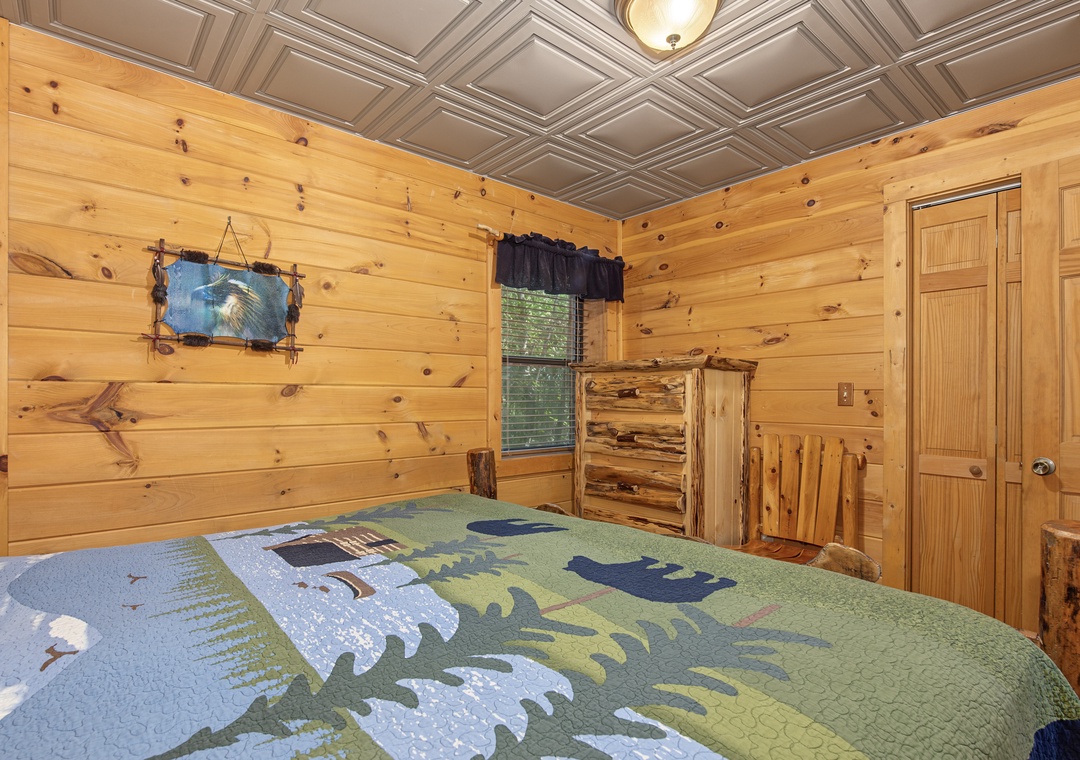 Rustic wood paneling and warm knotty pine surround your cozy retreat, where handcrafted log furniture and nature-inspired quilts invite you to unwind completely.
