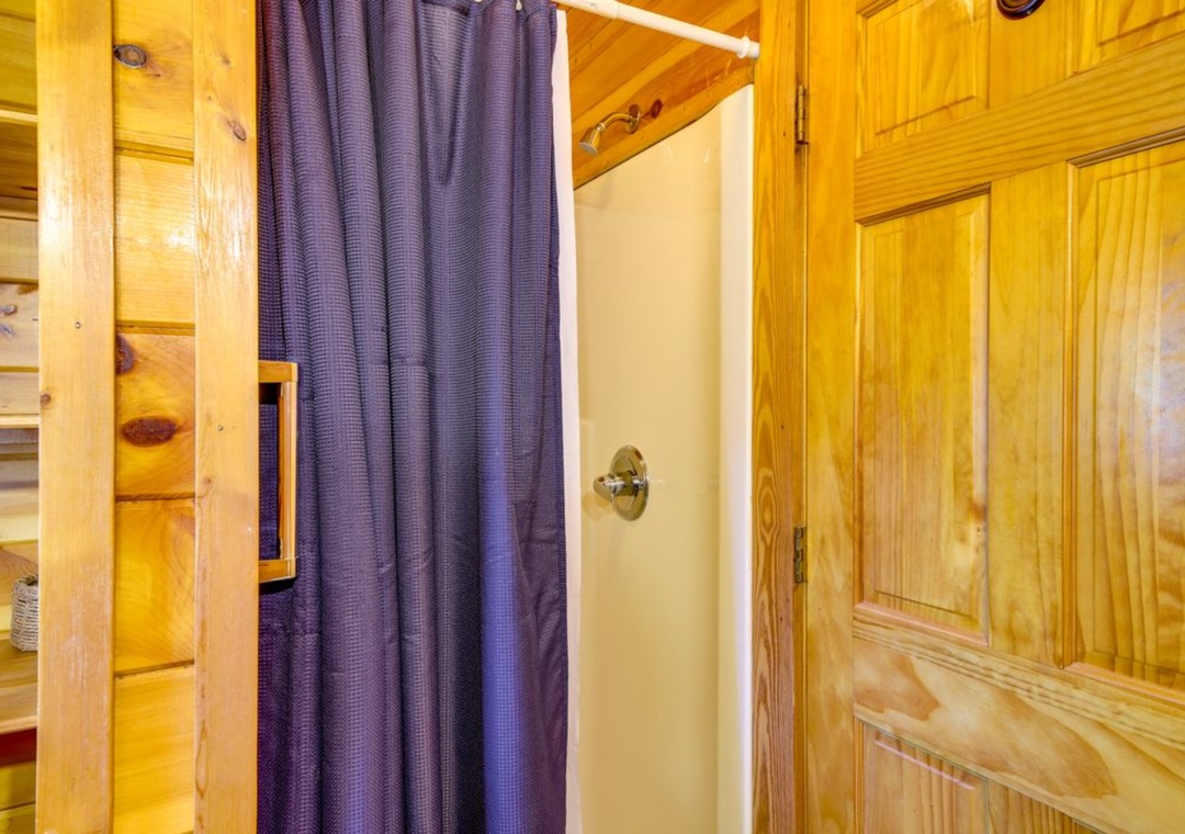 You'll love the rustic charm of this cozy bedroom with warm wood throughout and built-in storage for all your belongings.