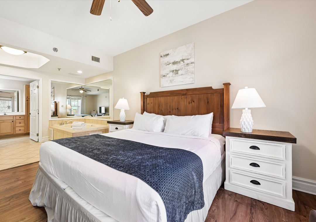 Sink into crisp linens and rustic charm in your spacious bedroom, where warm wood meets modern comfort for perfect relaxation.