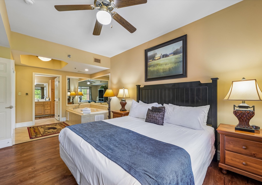 Unwind in your elegant bedroom with plush bedding and warm lighting, while enjoying your private spa tub just steps away.