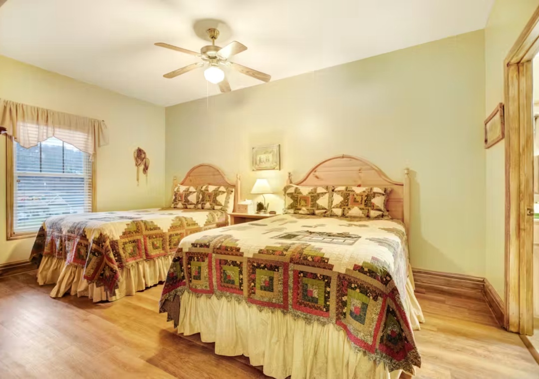 Drift into dreams in your cozy twin bedroom, where handcrafted quilts and warm wooden touches create a peaceful country retreat.