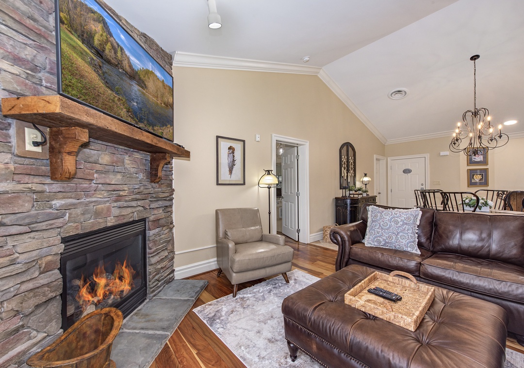 Cozy up by the crackling fireplace on plush leather furniture while watching your favorite shows on the flat-screen TV.