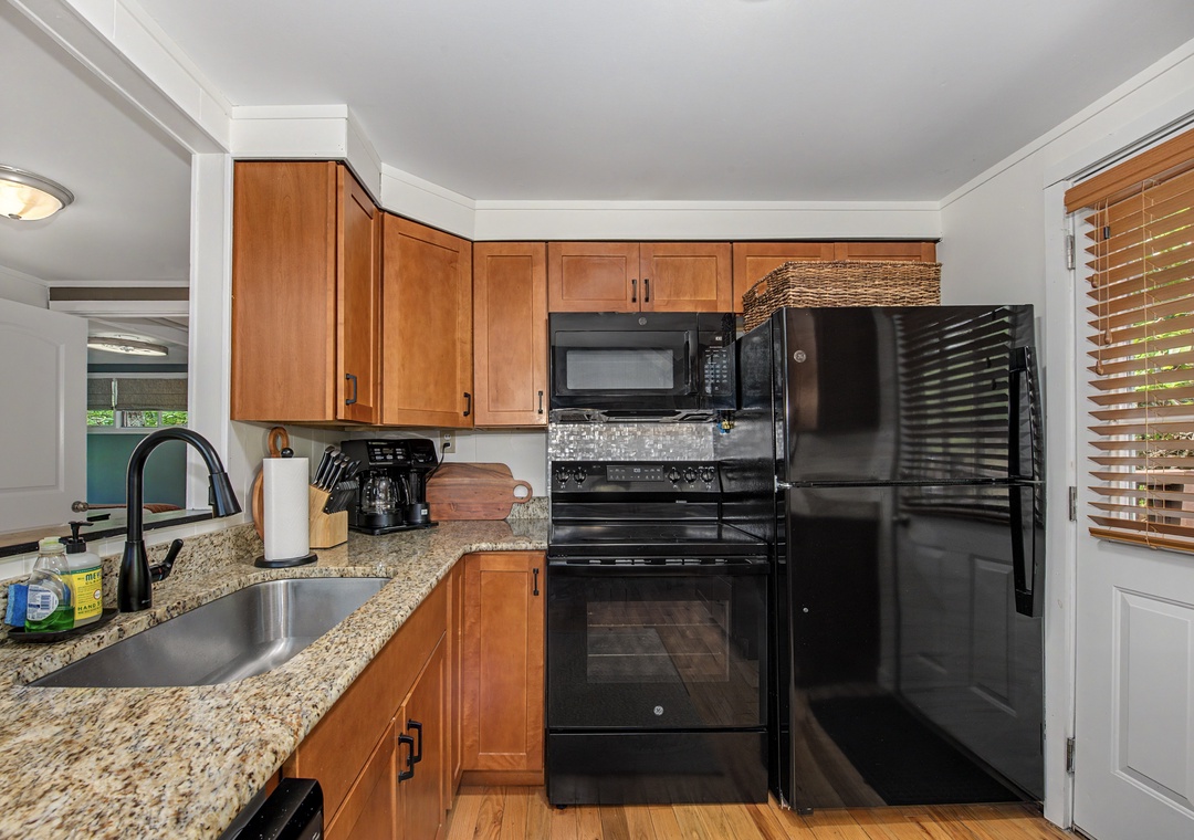 Your fully-equipped kitchen awaits with granite counters, modern appliances, and plenty of cabinet space for preparing meals during your stay.