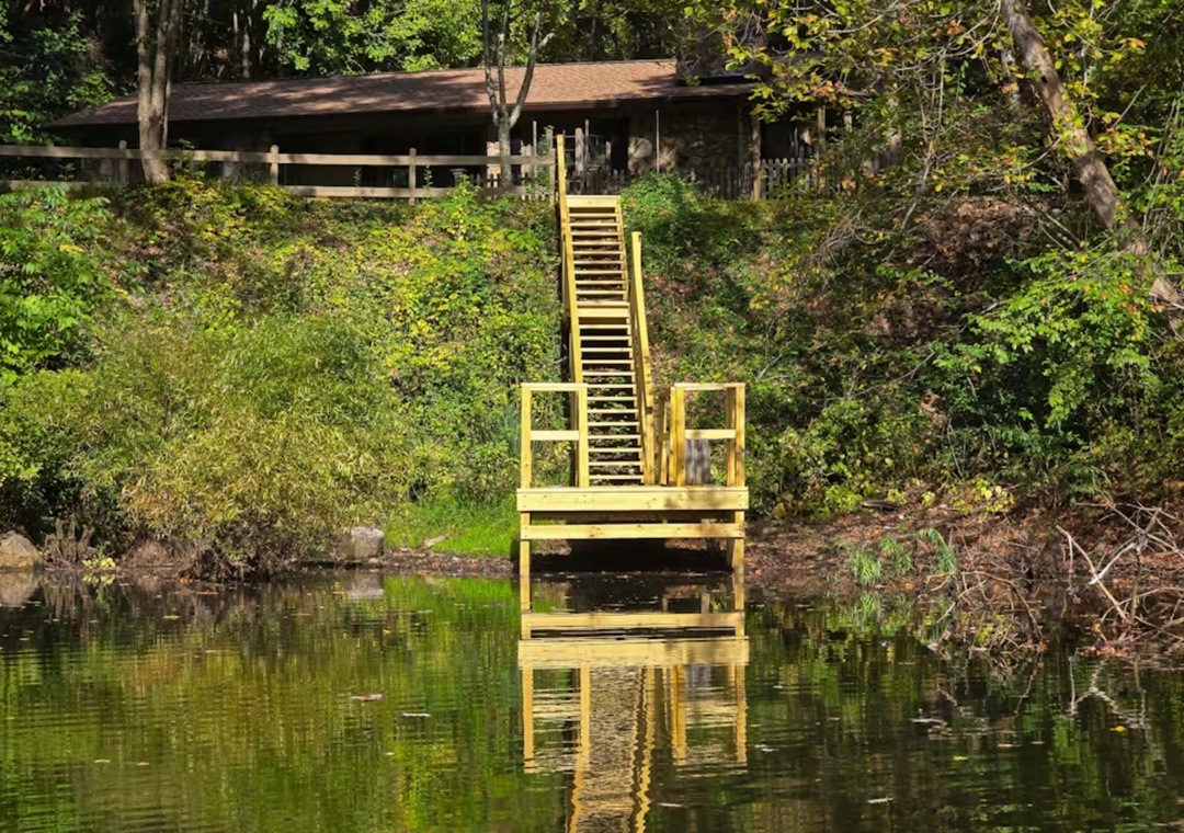 Private dock and ladder lead directly to the tranquil lake, where you can swim, fish, or simply soak in nature's serenity.