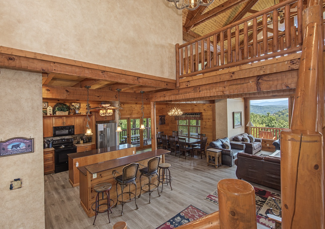Step into your mountain retreat—soaring timber ceilings, a chef's kitchen, and sweeping valley views through walls of windows invite you to unwind in rustic elegance.