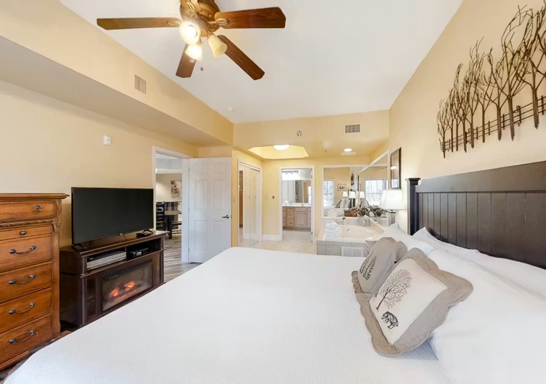 Relax in your spacious master suite with cozy fireplace, ceiling fan, and luxurious en-suite bathroom featuring a romantic soaking tub.