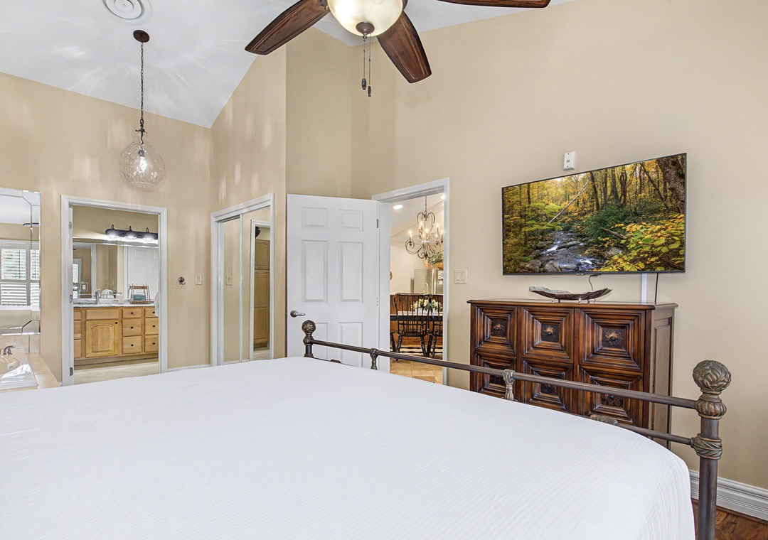 Drift off in your serene bedroom with vaulted ceilings, elegant furnishings, and peaceful nature artwork creating the perfect retreat.