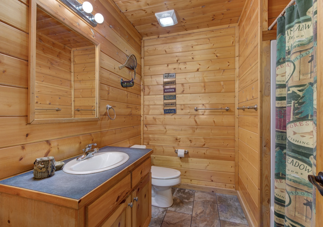 Step into your rustic bathroom where warm wood surrounds you with cozy cabin charm and modern comfort.
