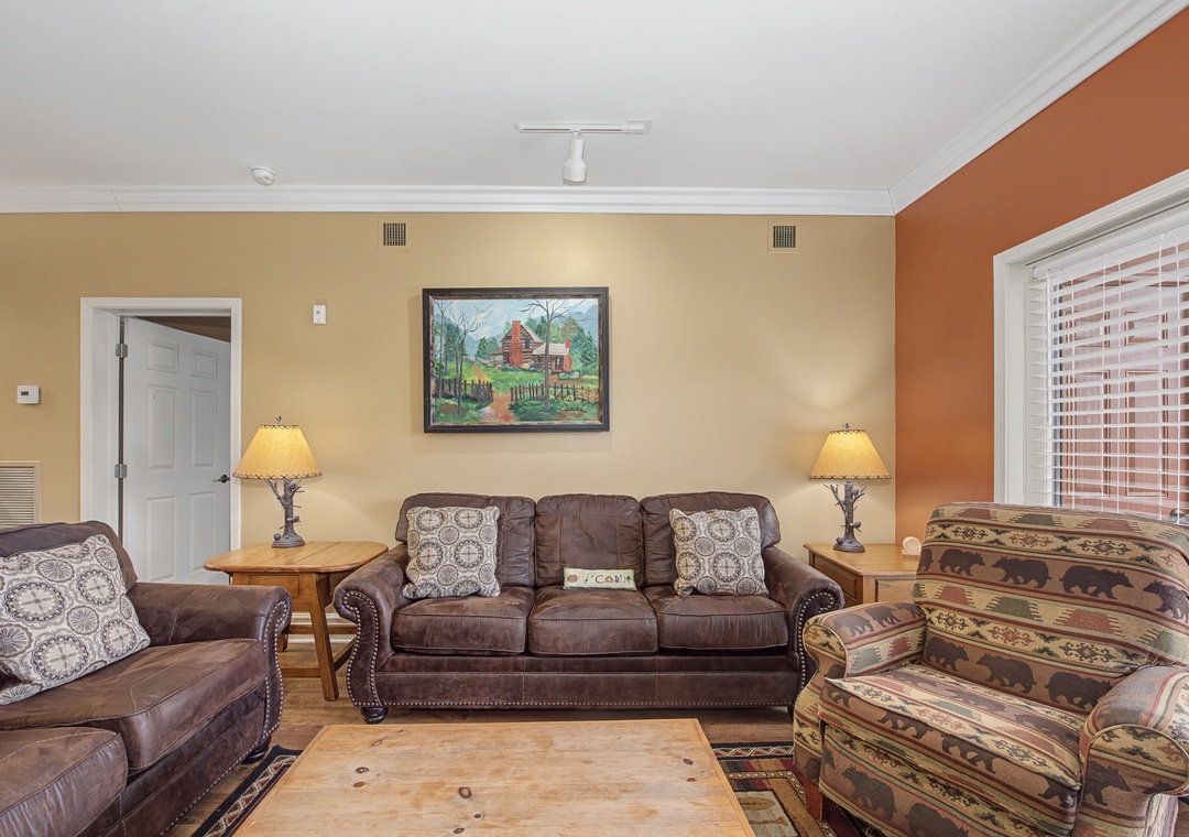 Sink into plush leather seating surrounded by warm cabin colors and rustic charm in your welcoming living space.