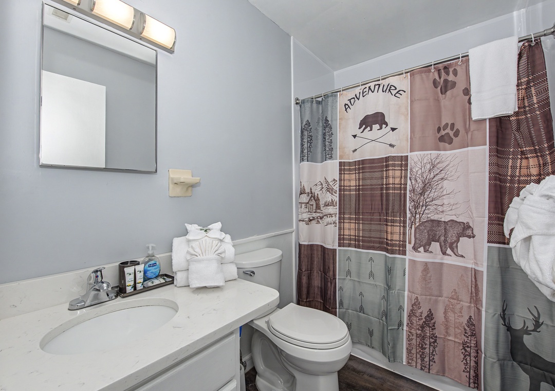 Refresh in your adventure-themed bathroom featuring a rustic woodland shower curtain and all the essentials for a comfortable stay.