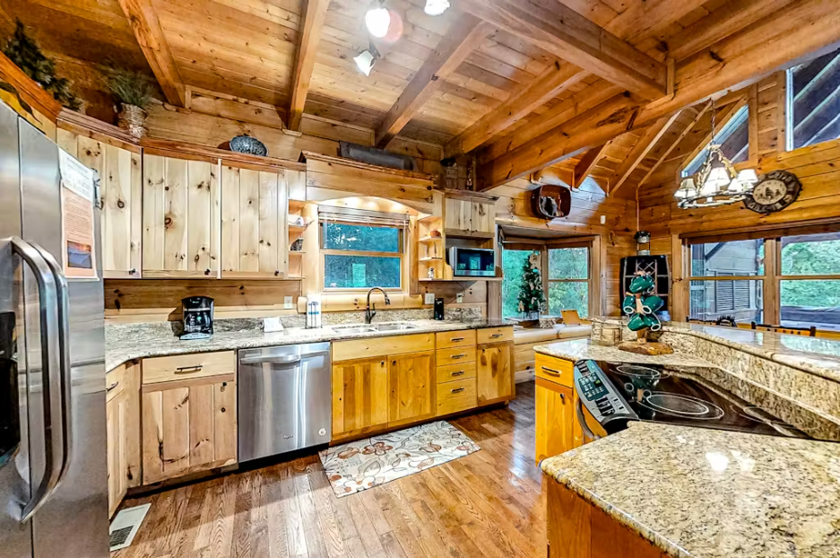 Cook gourmet meals in this stunning log cabin kitchen with granite counters and modern appliances.