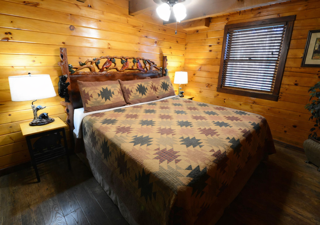 Cozy log cabin bedroom where you'll drift off surrounded by warm wood walls and rustic charm.