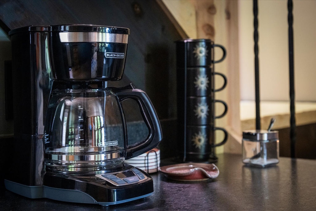 Start your mornings right with freshly brewed coffee from the Black+Decker coffee maker, ready to energize your day in this thoughtfully equipped kitchen.