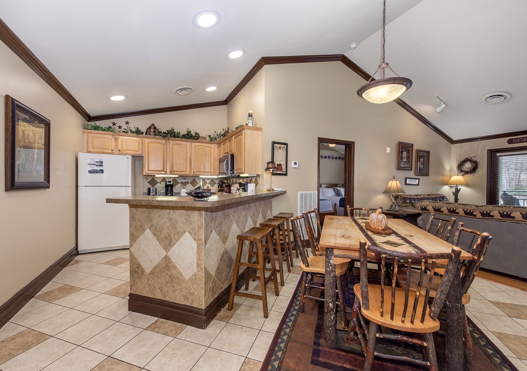 Your spacious kitchen flows seamlessly into the dining area, perfect for cooking together and sharing memorable meals around the rustic wooden table.