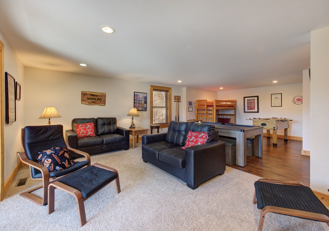 Sink into these comfortable leather sofas after your mountain adventures, with a fun game table and bunk beds perfect for families.