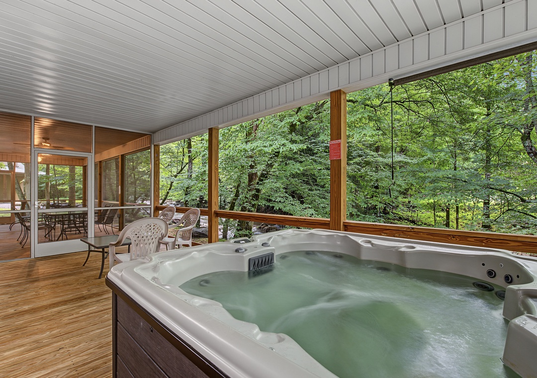 Soak in your private hot tub while surrounded by lush forest views through floor-to-ceiling windows. Perfect for unwinding after exploring the area.