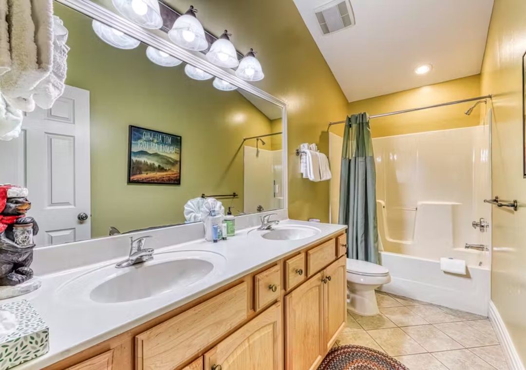 Refresh in your spacious bathroom featuring dual vanities and a soothing tub-shower combo after days of adventure.