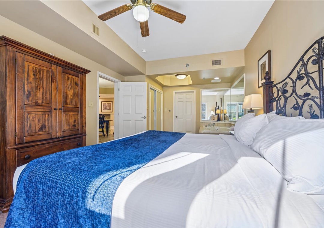 Relax in your elegant suite featuring plush bedding, rustic wood furnishings, and an open-concept design with spa bathroom.