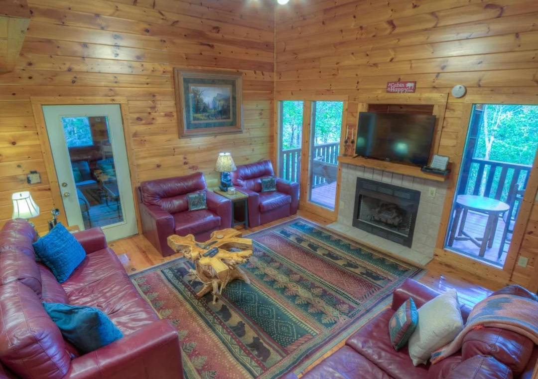 Sink into plush leather seating and warm up by your cozy fireplace while enjoying views of lush greenery from your private deck—your mountain retreat awaits.