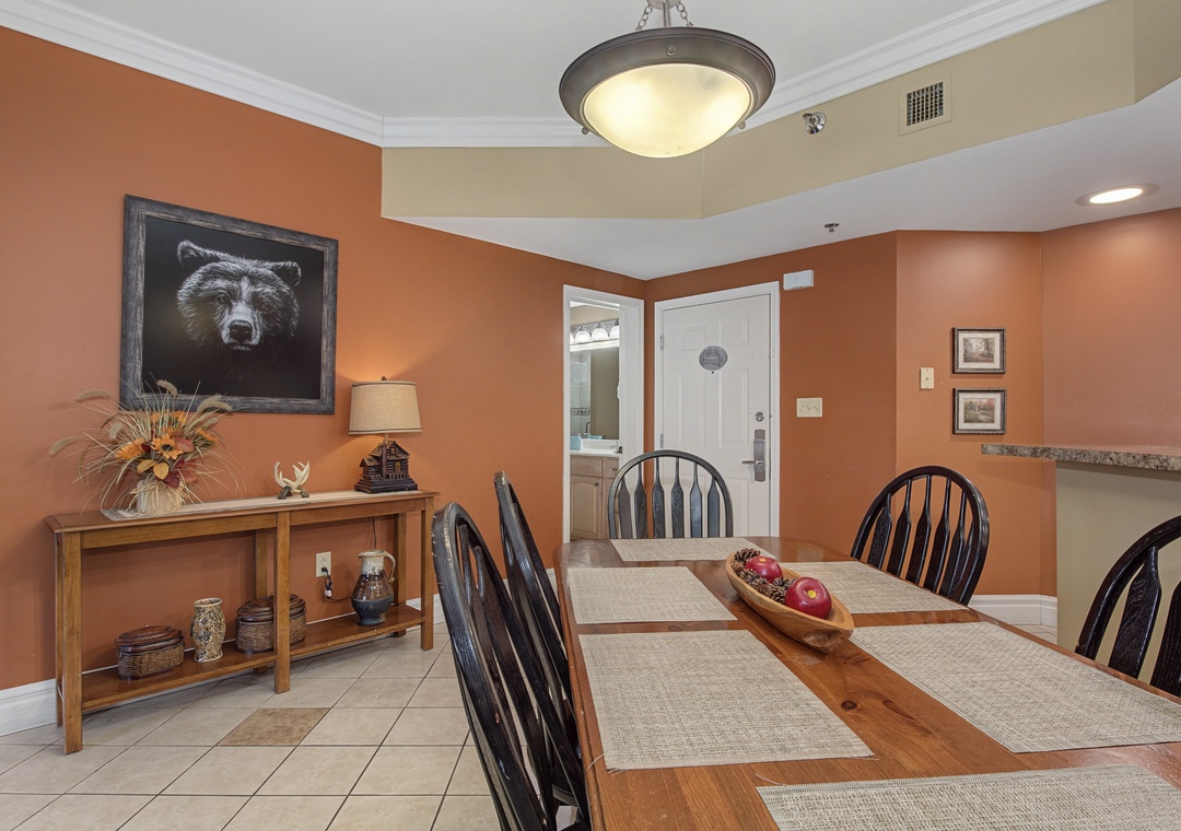 Gather around this warm dining space featuring rich terracotta walls and rustic charm for memorable meals together.