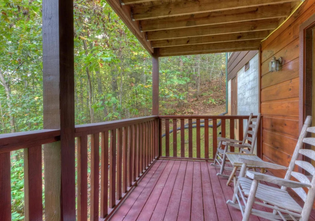 Step onto your private covered balcony and breathe in the fresh forest air—your peaceful retreat among the trees, perfect for morning coffee or evening relaxation.