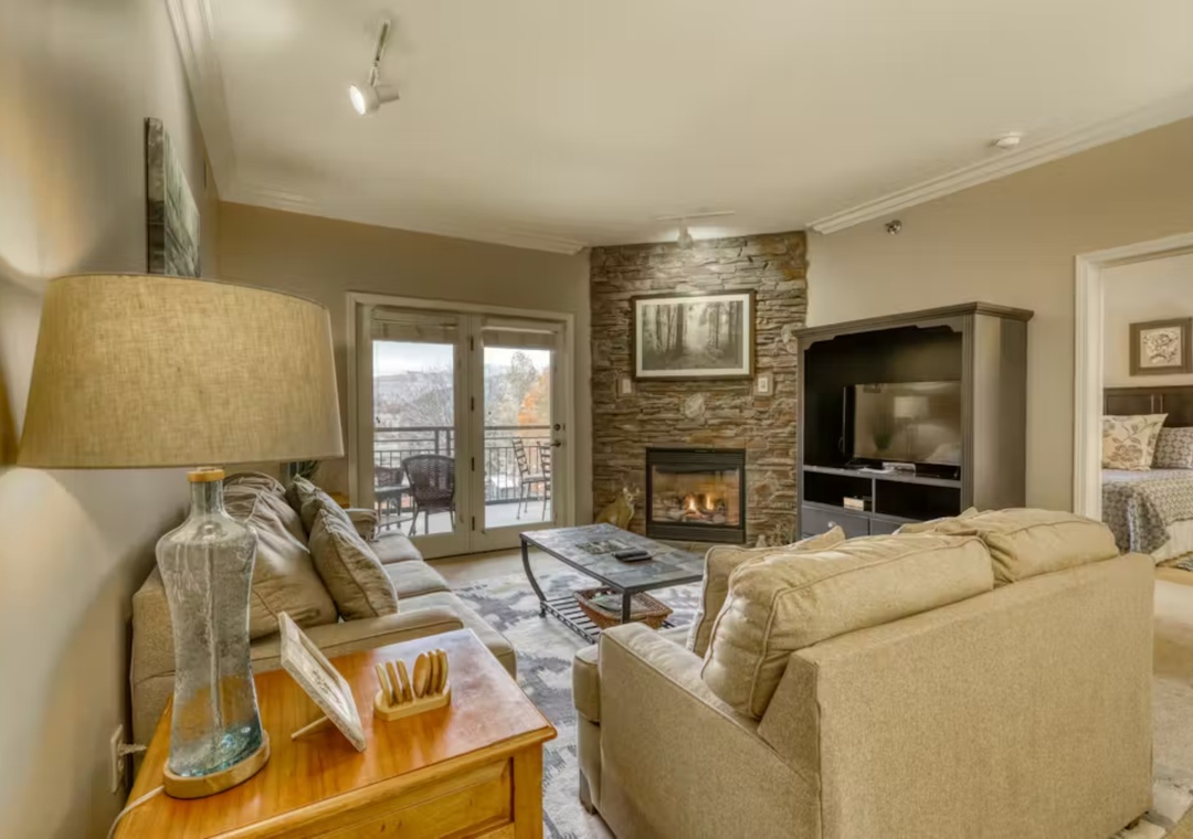 Settle into your cozy living room with a crackling fireplace and mountain views from your private balcony.