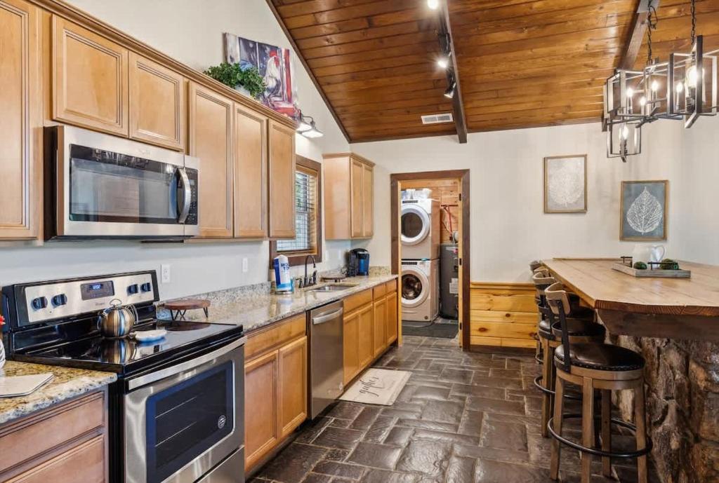 Cook, gather, and unwind in this inviting kitchen with warm wood accents, granite counters, and a charming breakfast bar—perfect for your mountain getaway meals.