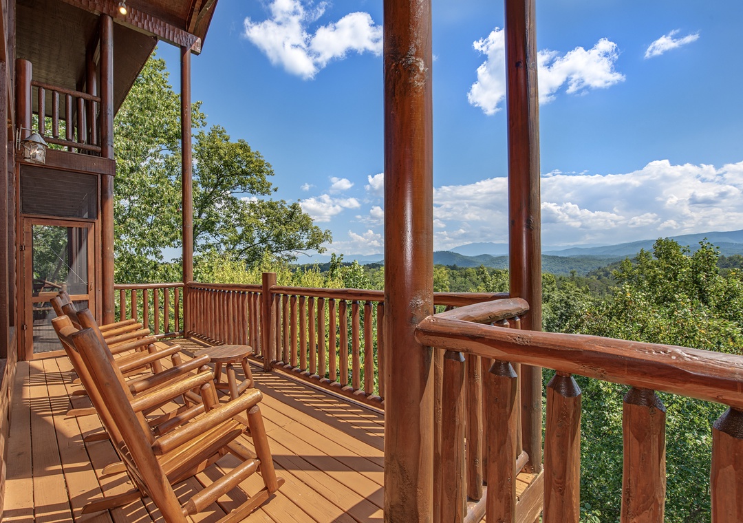 Relax in handcrafted log rocking chairs on your private balcony while soaking in sweeping mountain vistas and lush forest views under open skies—your perfect spot to unwind and reconnect with nature.
