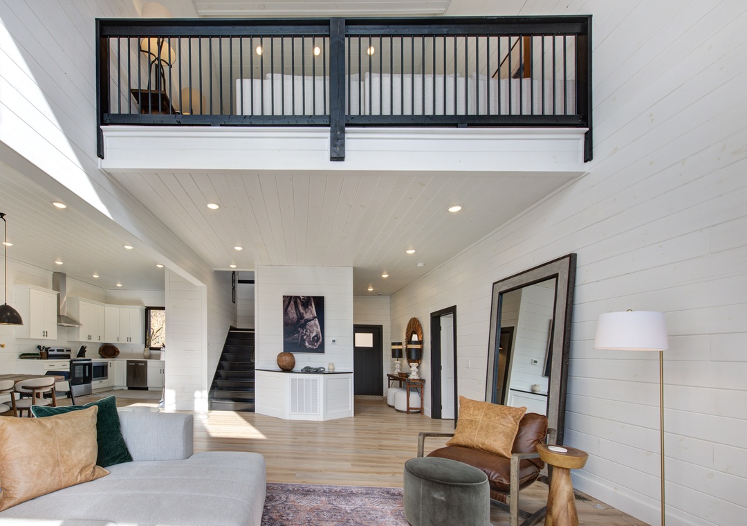 Relax in this stunning open-concept space where modern comfort meets rustic charm, with soaring ceilings and a cozy loft overlooking your stylish retreat.