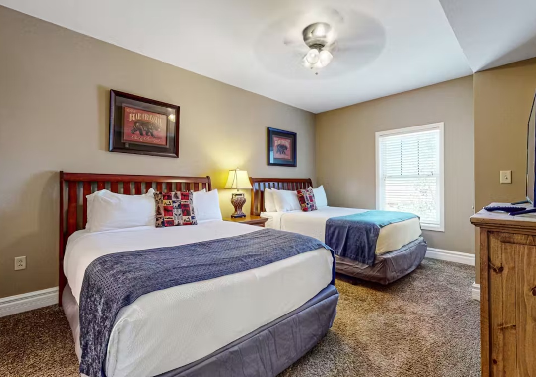Relax in your cozy twin bedroom featuring rustic charm with warm lighting, plush bedding, and thoughtful decor perfect for your restful retreat.