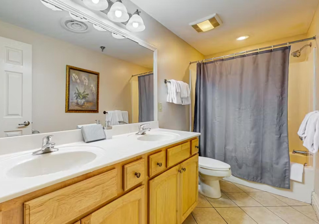 Your spacious bathroom offers dual sinks and a relaxing tub-shower combo, perfect for refreshing after your adventures.