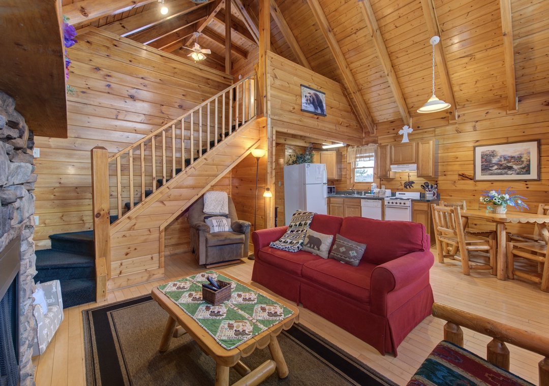 Unwind in your cozy cabin retreat with exposed beams, stone fireplace, and rustic charm creating the perfect mountain getaway atmosphere.