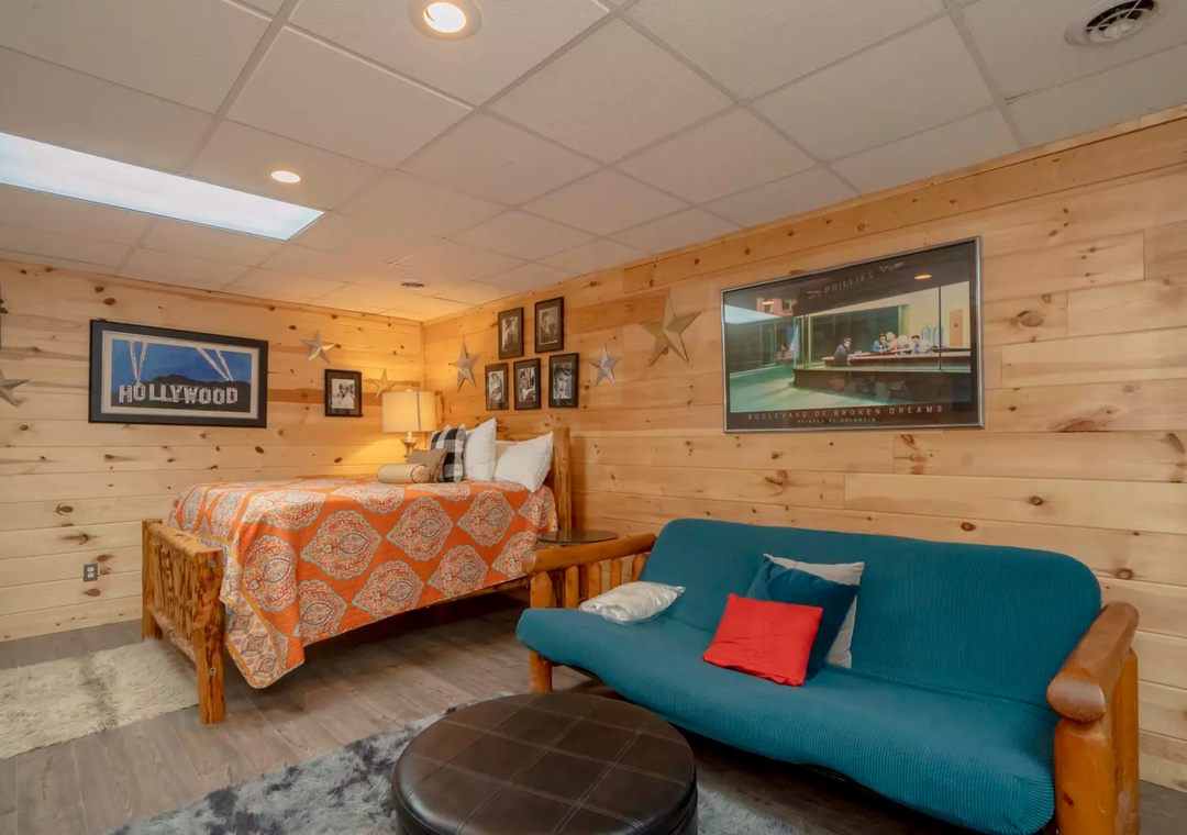 Cozy rustic retreat with warm wood walls, comfortable bed, and vibrant seating area where you can unwind after mountain adventures.