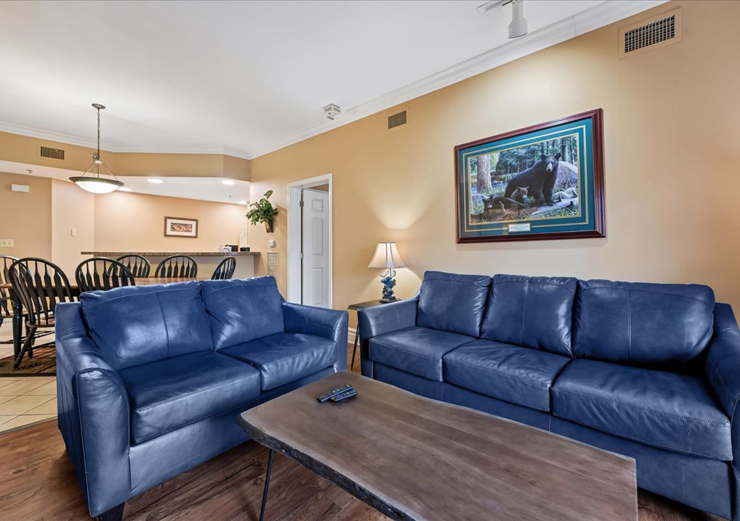Sink into plush blue leather sofas in your spacious living area, perfect for unwinding after exploring nearby adventures.