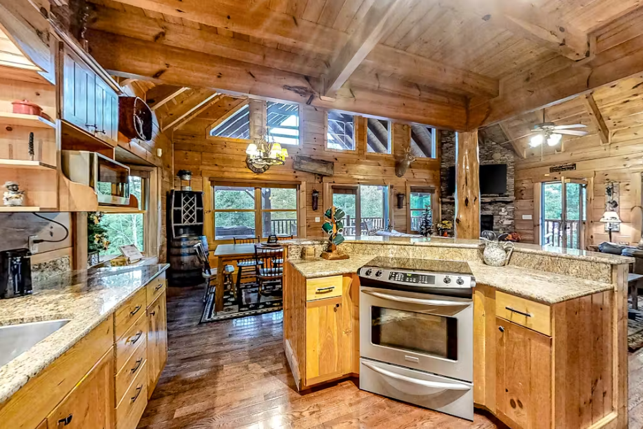 Craft culinary memories in this stunning log cabin kitchen with granite counters, modern appliances, and warm wood beams overhead.