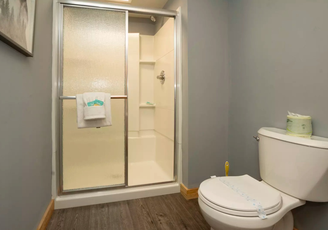 Step into your private bathroom featuring a spacious walk-in shower and modern fixtures, designed for your comfort and convenience.